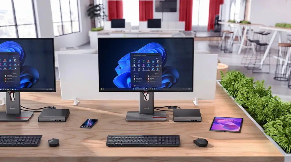 Lenovo ThinkCentre Neo 50q Gen 6 (Intel) Tiny PC in modern office, dual monitors displaying Windows menu & some accessories placed on the desk.