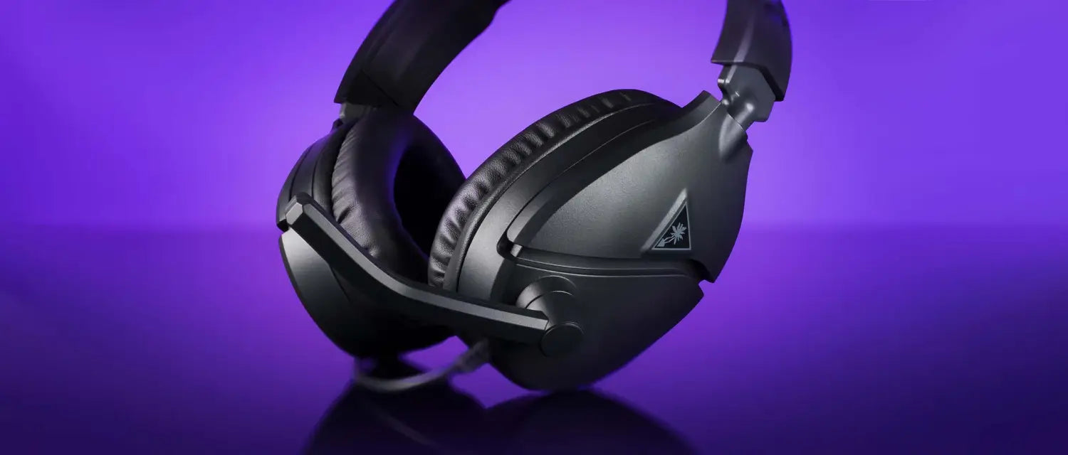 Sleek black Recon 70 gaming headset with plush ear cushions on purple background