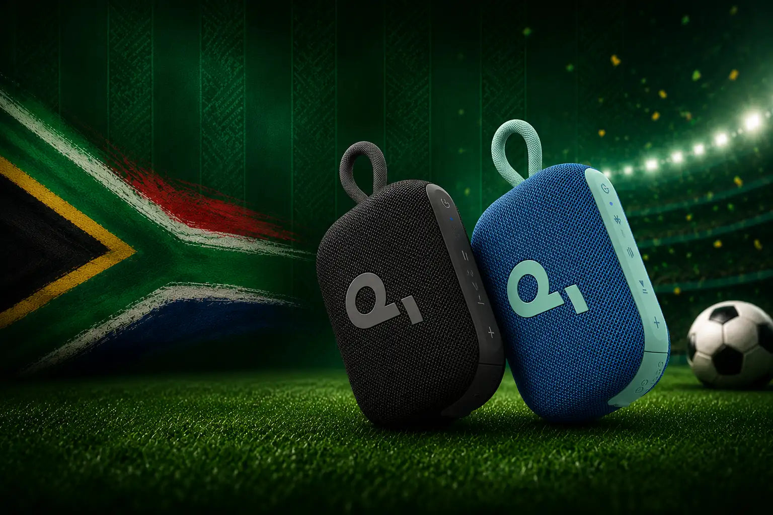 Two compact, fabric-wrapped portable bluetooth speakers , one black and one blue with light teal accents , each featuring a loop handle and the ’q1’ logo.